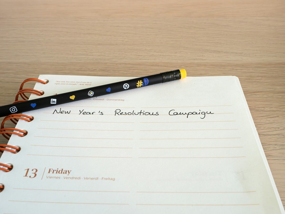 Notebook and pen on desk with coffee